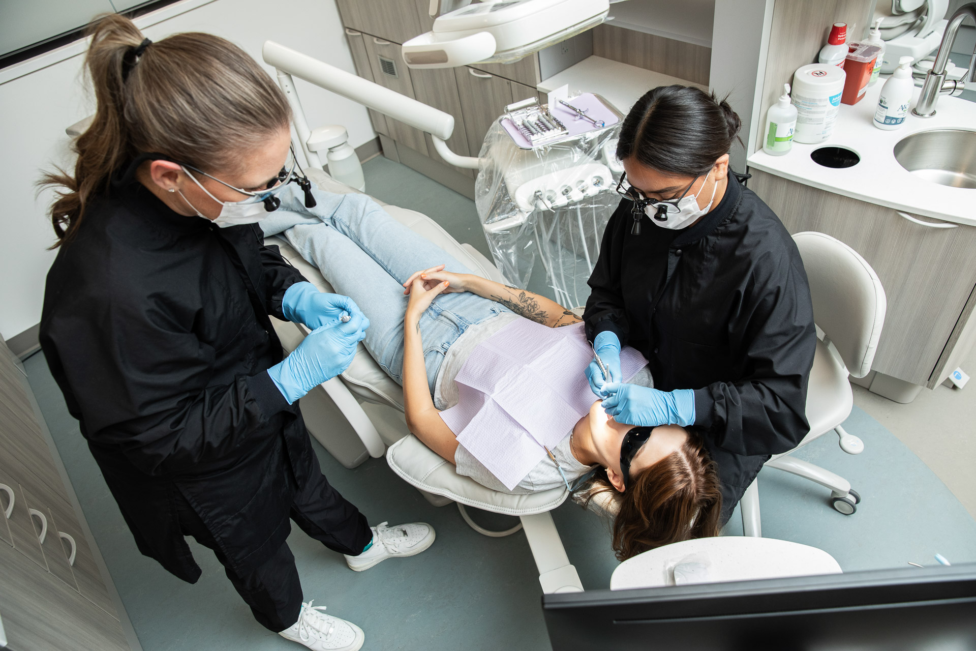 Dental hygienists working with patient