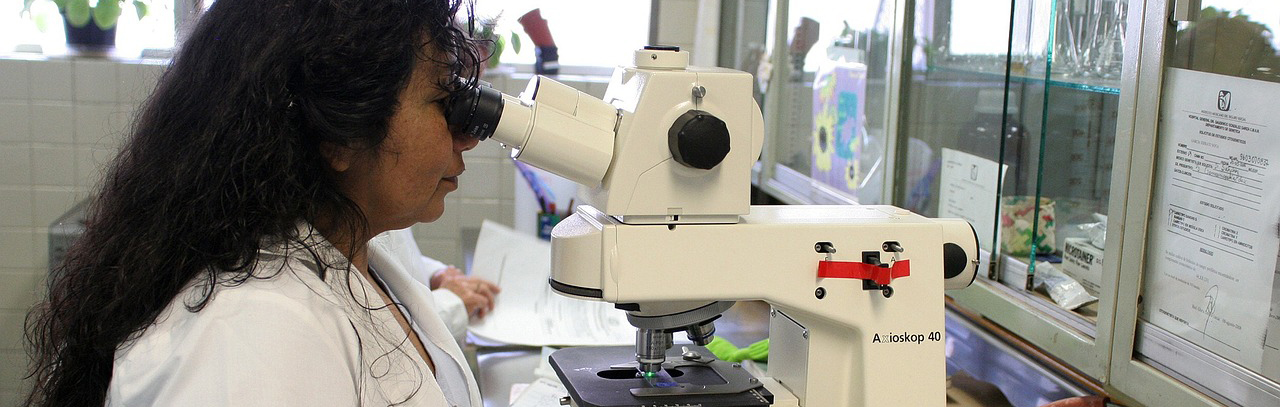 Person using microscope in a biochemistry setting