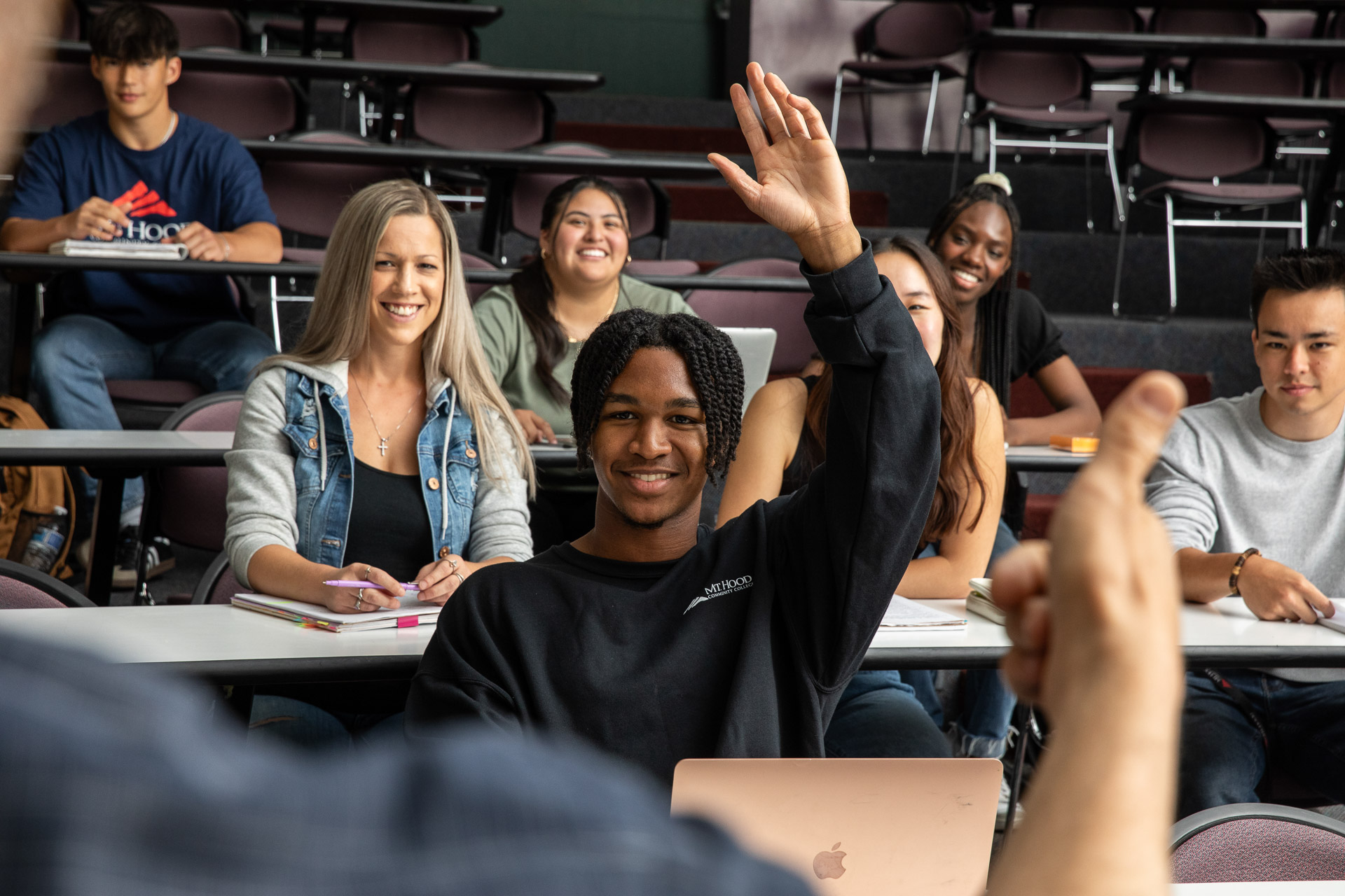 Student in class raising their hand.