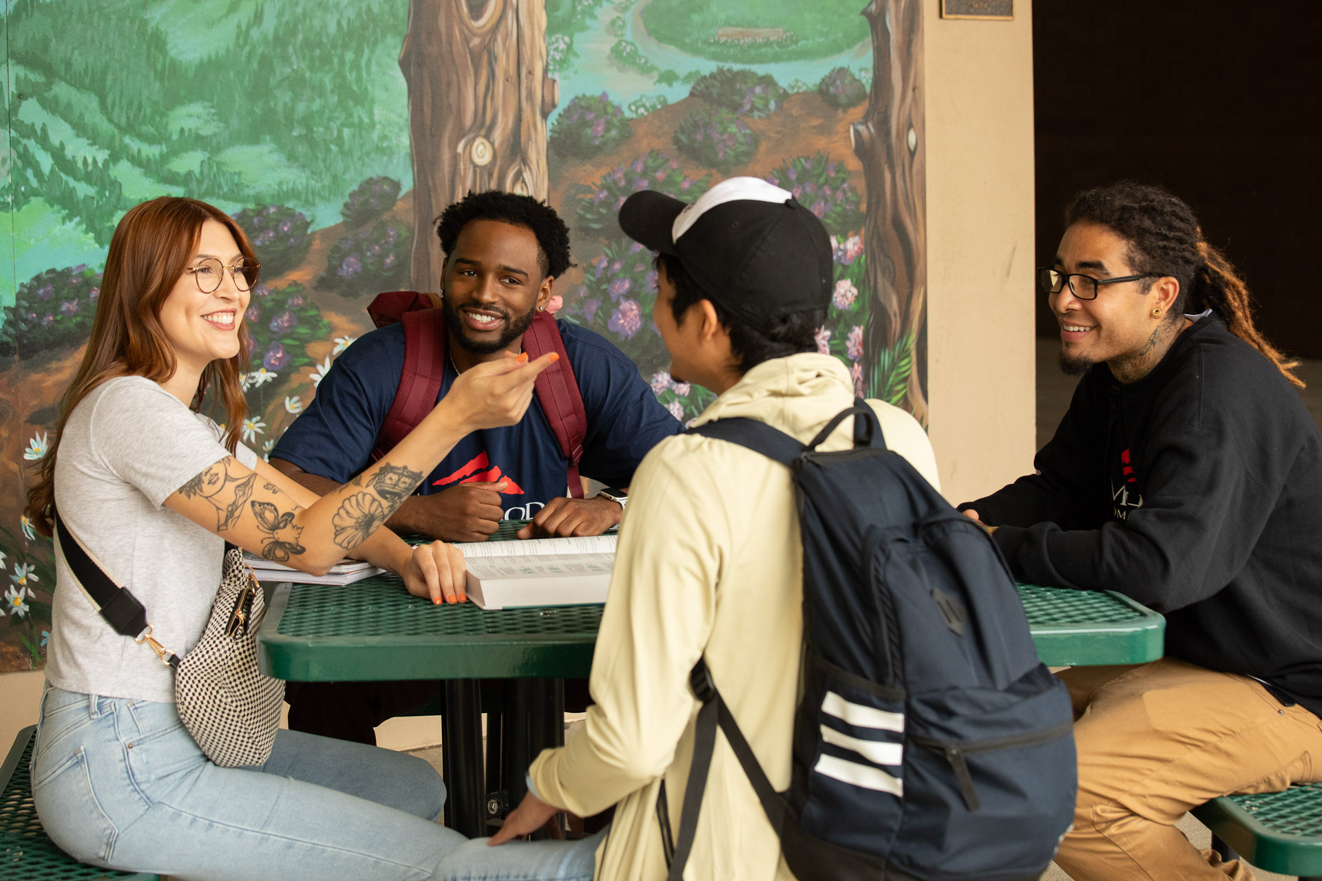 four students sitting at a table