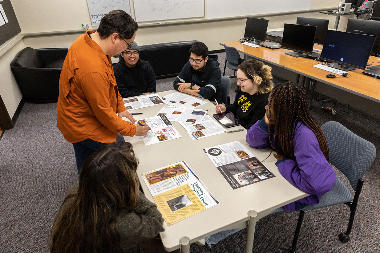 Students and instructor collaborating at a table