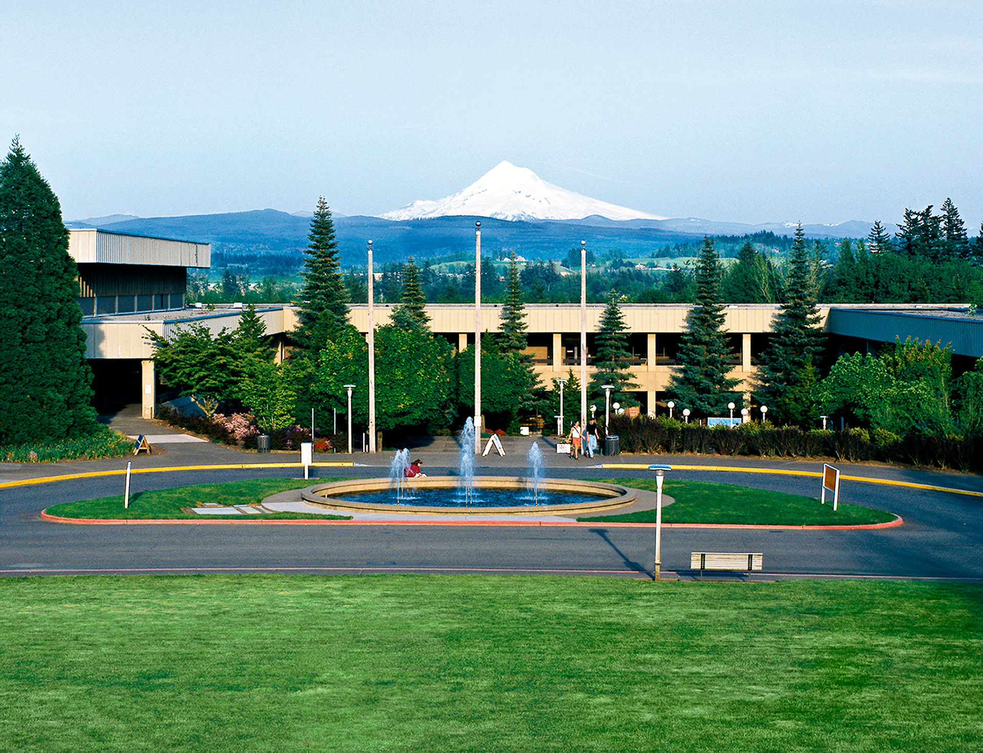 Image of MHCC Gresham campus with fountain in front and Mt. Hood in the background