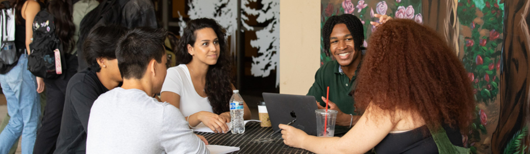 students at table on campus