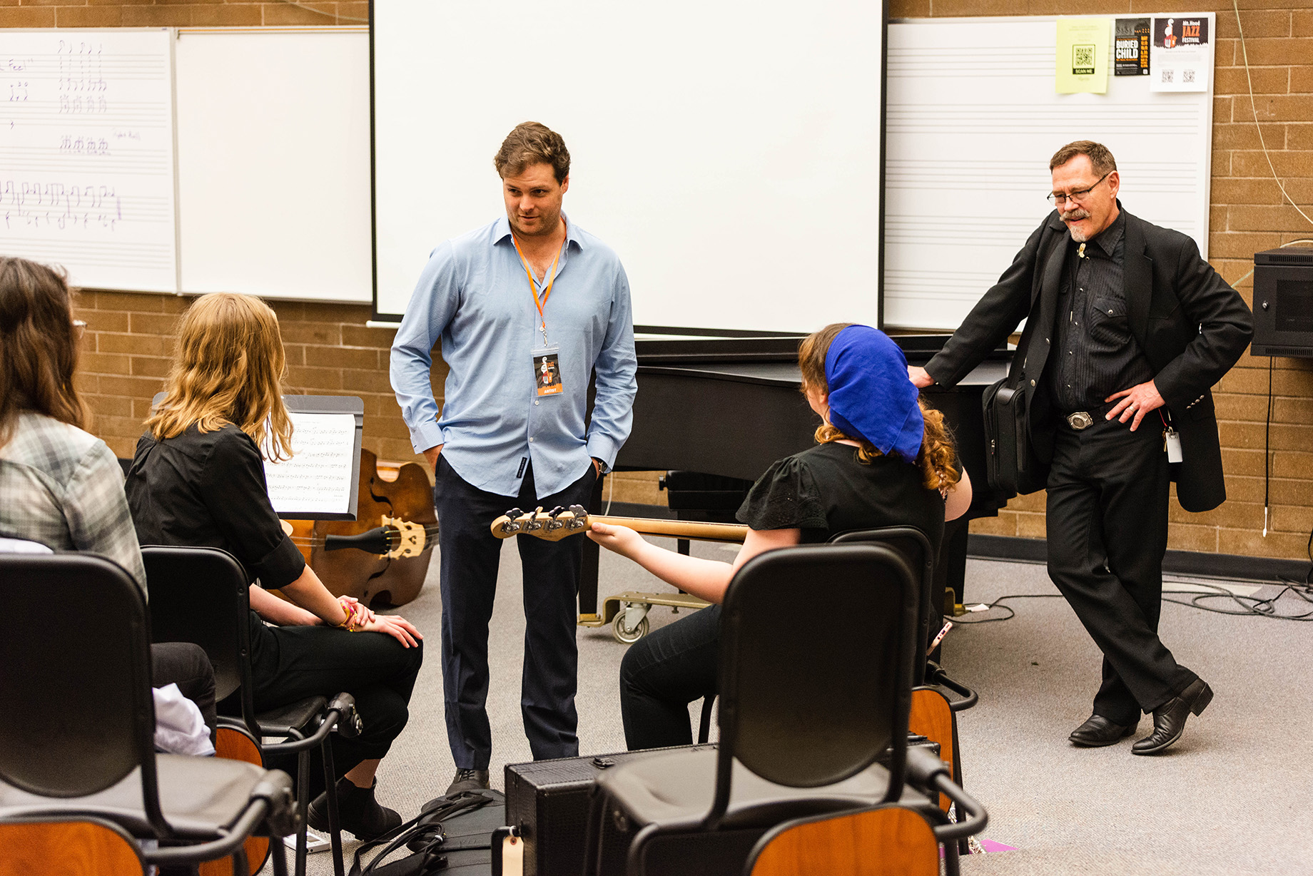 Instructor talking with music students